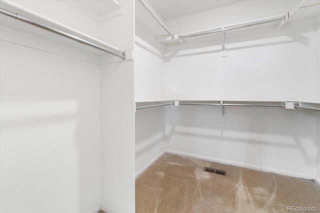 spacious closet with carpet floors and visible vents