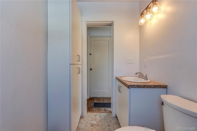 bathroom featuring vanity and toilet