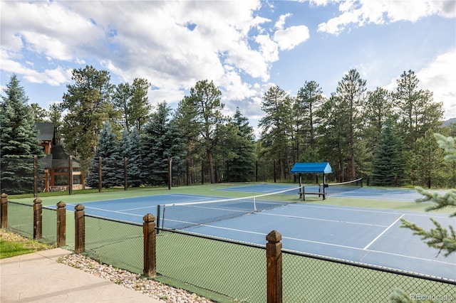 view of tennis court with fence