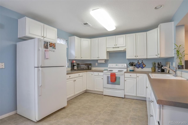 kitchen with white appliances, visible vents, a sink, white cabinets, and under cabinet range hood