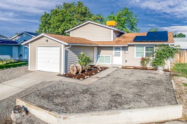5791/2 Fairfield Ct, Grand Junction, CO 81504 - view of front of property with a garage, driveway, solar panels, and roof with shingles