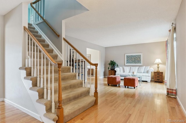 staircase featuring wood-type flooring