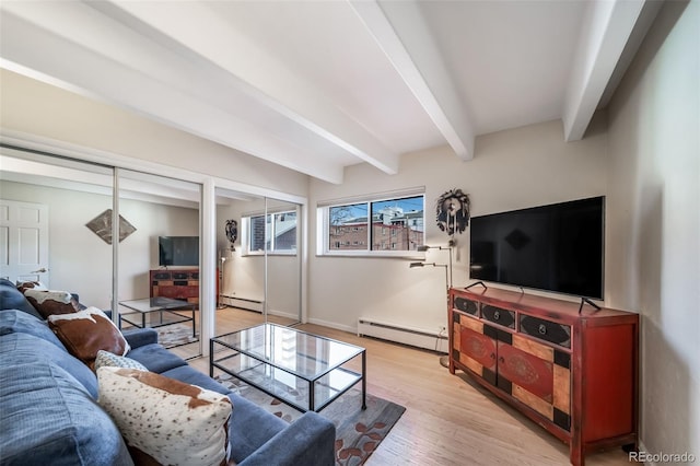 living area featuring a baseboard heating unit, beamed ceiling, and light wood-style flooring