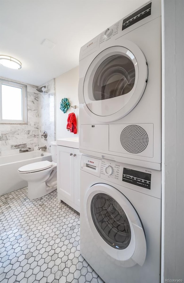 clothes washing area with stacked washer and clothes dryer