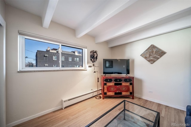 33 N Corona St Unit 205, Denver, CO 80218 - living area featuring baseboard heating, beamed ceiling, wood finished floors, and baseboards