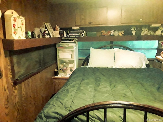 bedroom featuring wood walls