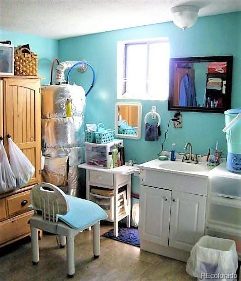 bathroom featuring a textured ceiling and sink