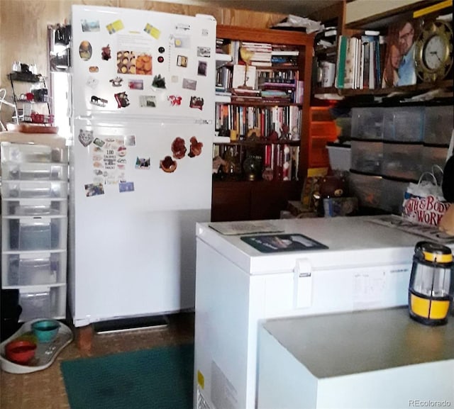 kitchen with washer / dryer and white fridge