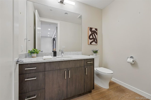 250 Columbine St Unit 310, Denver, CO 80206 - bathroom featuring wood finished floors, vanity, toilet, and baseboards