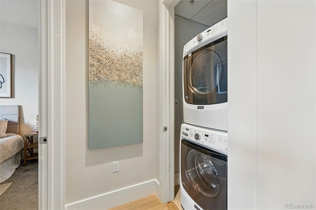 250 Columbine St Unit 310, Denver, CO 80206 - washroom with stacked washer and clothes dryer and baseboards