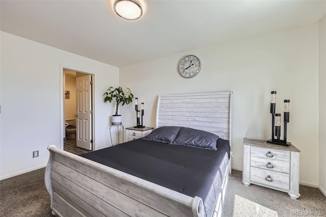 carpeted bedroom featuring ensuite bath and baseboards