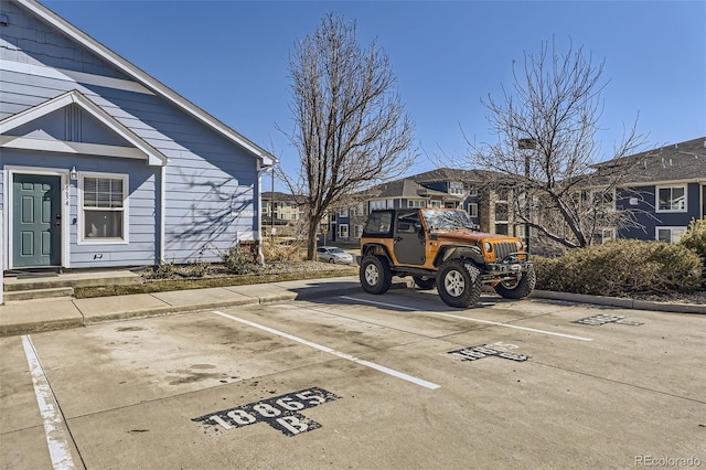 uncovered parking lot featuring a residential view