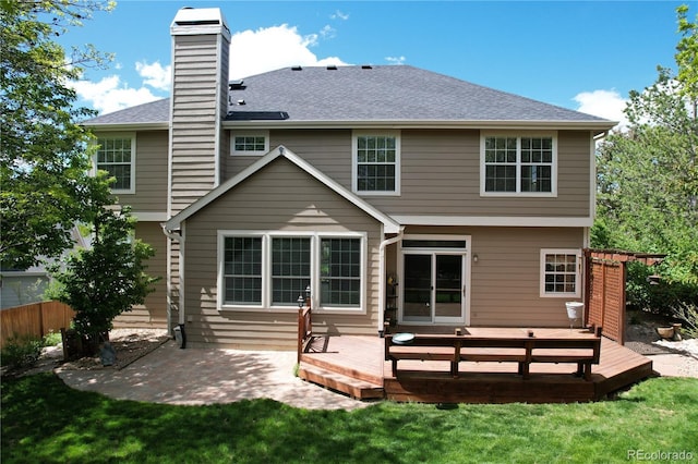 2141 Weatherstone Cir, Highlands Ranch, CO 80126 - back of house with a patio area, a chimney, a deck, and a shingled roof