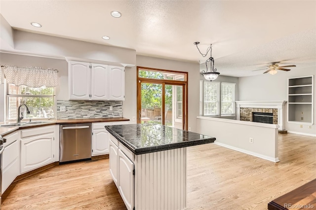 2141 Weatherstone Cir, Highlands Ranch, CO 80126 - kitchen featuring a sink, dishwasher, a ceiling fan, light wood-style floors, and a textured ceiling