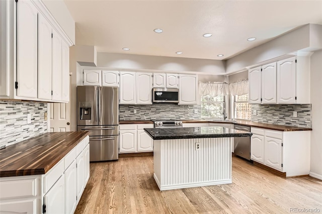 2141 Weatherstone Cir, Highlands Ranch, CO 80126 - kitchen featuring appliances with stainless steel finishes, wooden counters, tasteful backsplash, and recessed lighting