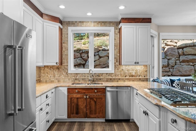 kitchen with appliances with stainless steel finishes, white cabinetry, and sink