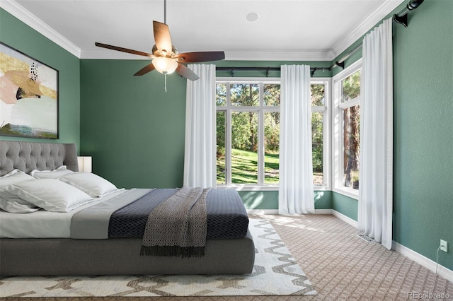 bedroom featuring ceiling fan, light carpet, and ornamental molding