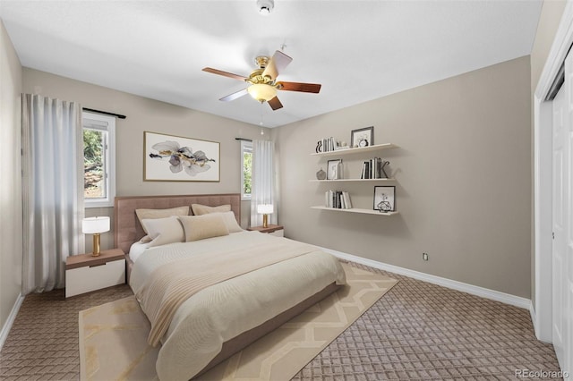 carpeted bedroom featuring ceiling fan and a closet