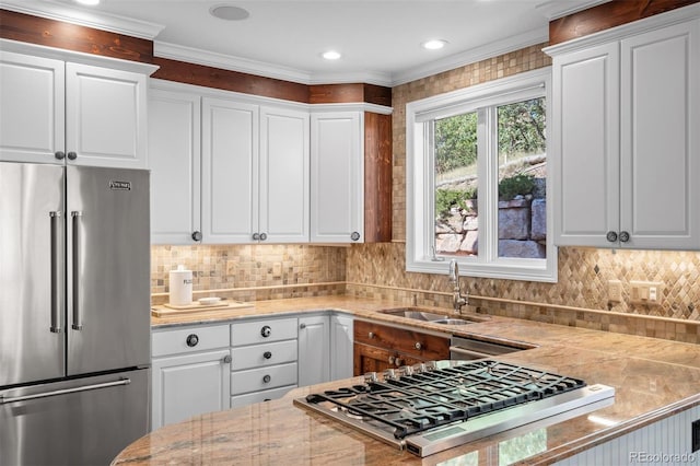 kitchen with stainless steel appliances, white cabinets, and sink