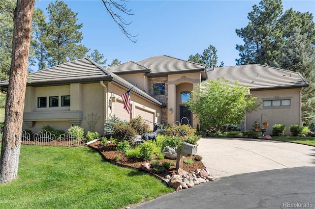 view of front of home featuring a garage and a front lawn