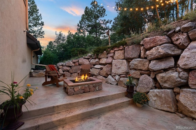 patio terrace at dusk with an outdoor fire pit