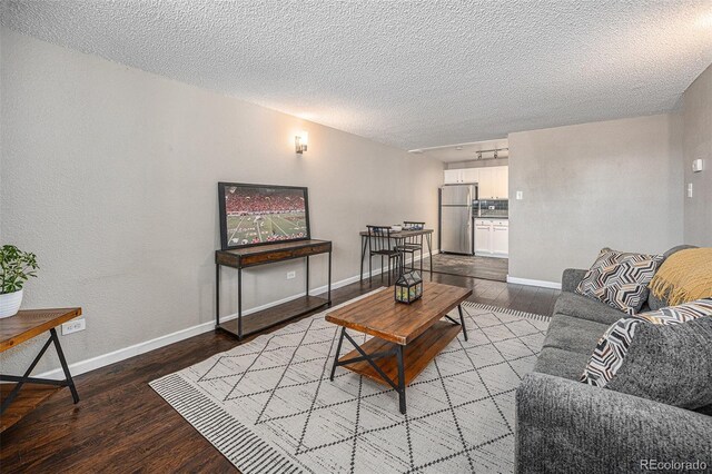 3047 W 47th Ave Unit 109, Denver, CO 80211 - living room featuring wood finished floors, a textured ceiling, and a textured wall