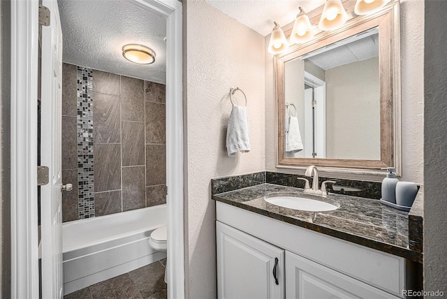 3047 W 47th Ave Unit 109, Denver, CO 80211 - bathroom featuring vanity, a textured ceiling, a textured wall, and shower / bath combination