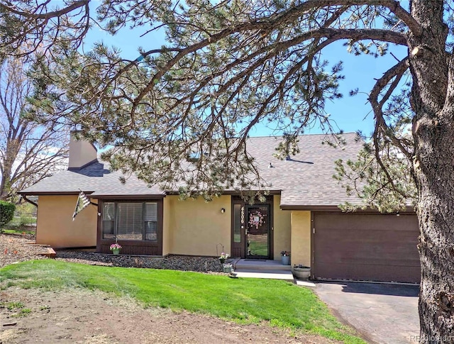 4506 Winewood Village Dr, Colorado Springs, CO 80917 - view of front of house with stucco siding, a shingled roof, asphalt driveway, and a front lawn