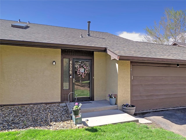 4506 Winewood Village Dr, Colorado Springs, CO 80917 - property entrance featuring a shingled roof, stucco siding, and a garage