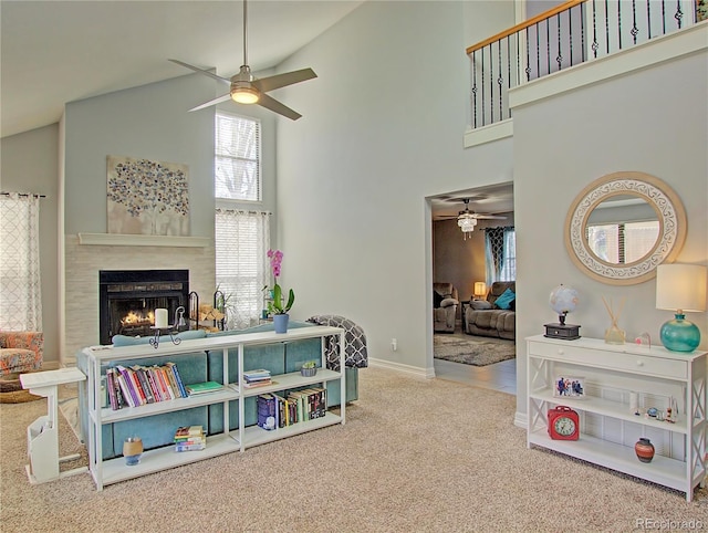 4506 Winewood Village Dr, Colorado Springs, CO 80917 - living area with a ceiling fan, high vaulted ceiling, carpet, a lit fireplace, and baseboards