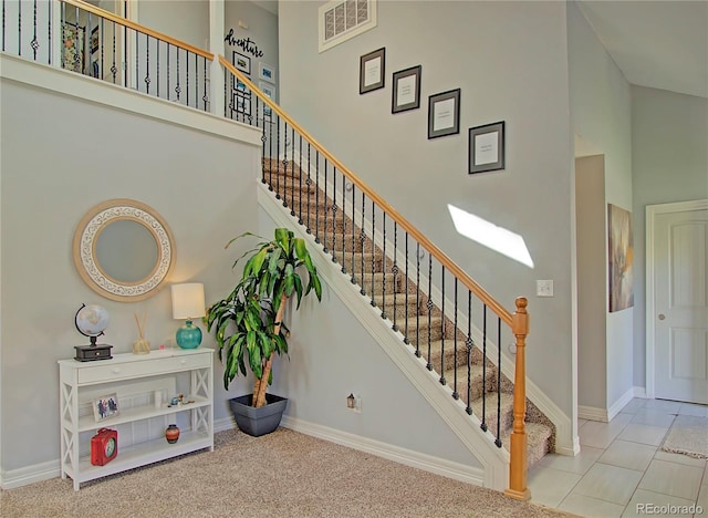 4506 Winewood Village Dr, Colorado Springs, CO 80917 - stairway with a towering ceiling and baseboards