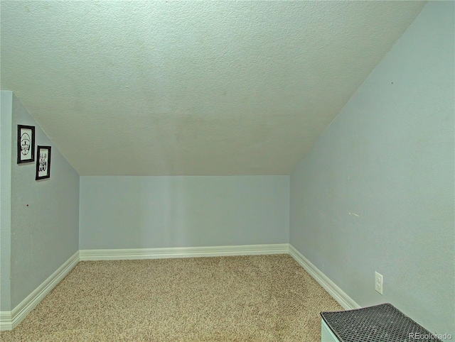 4506 Winewood Village Dr, Colorado Springs, CO 80917 - bonus room featuring light colored carpet, lofted ceiling, baseboards, and a textured ceiling