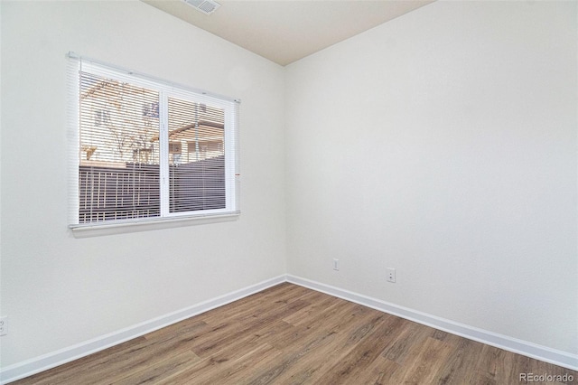 spare room featuring wood-type flooring