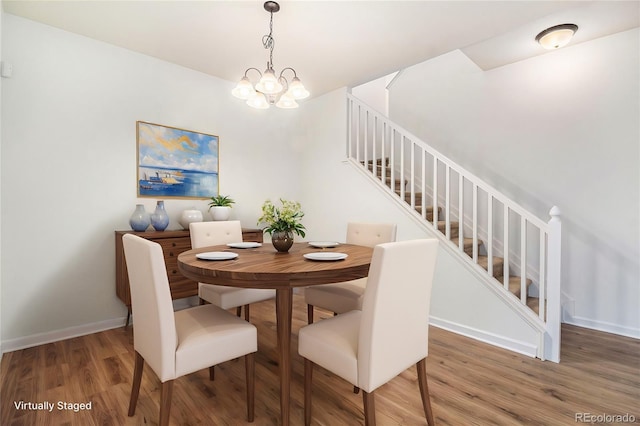 dining space with a chandelier and wood-type flooring