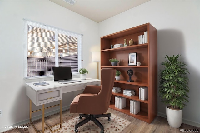 office area with light hardwood / wood-style floors