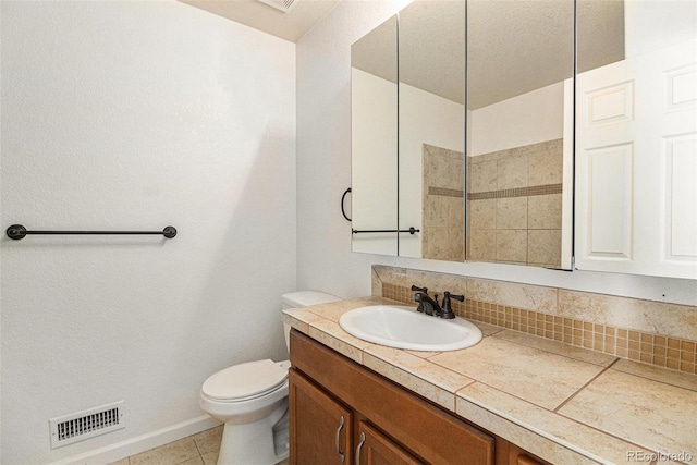 bathroom featuring tile patterned floors, vanity, tasteful backsplash, and toilet