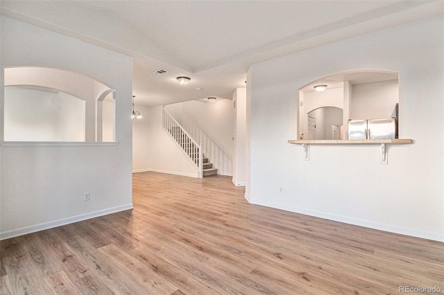 unfurnished living room featuring hardwood / wood-style flooring