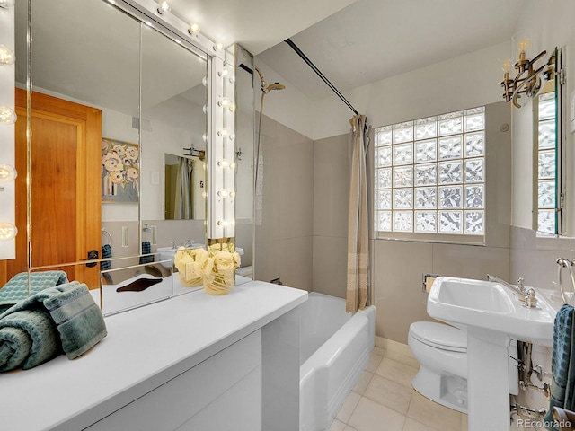 bathroom with tile patterned flooring, toilet, and shower / bath combo with shower curtain