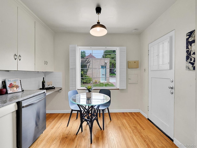 dining area featuring light wood-type flooring and baseboards