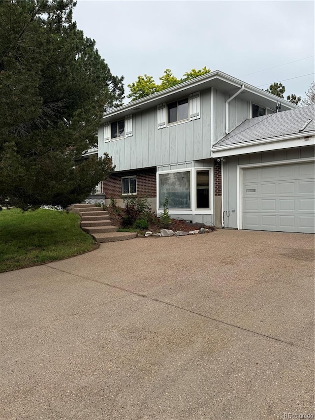3566 E Fair Pl, Centennial, CO 80121 - view of front of house with concrete driveway, a garage, and board and batten siding