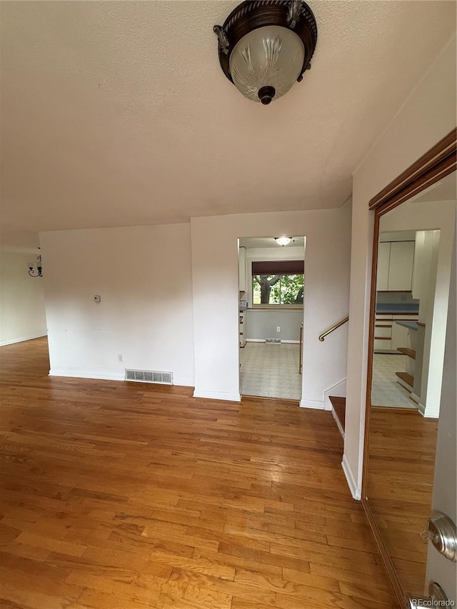 3566 E Fair Pl, Centennial, CO 80121 - unfurnished dining area with light wood-style floors and stairs