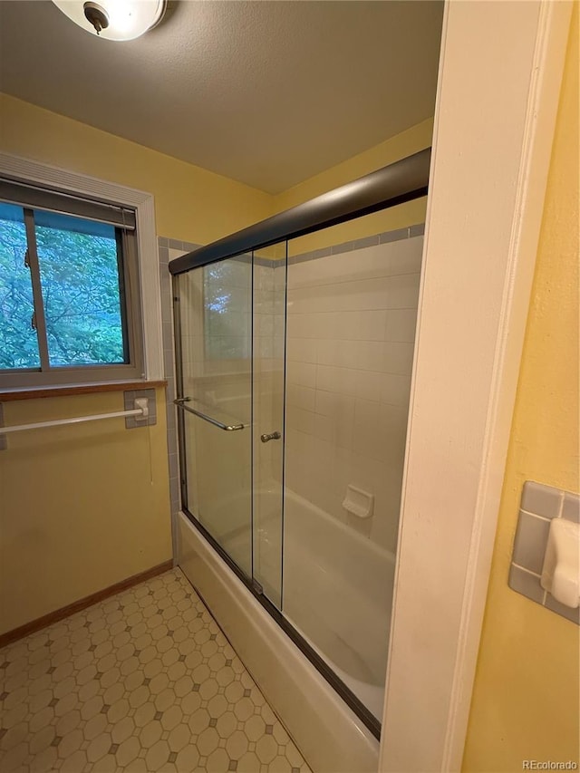 3566 E Fair Pl, Centennial, CO 80121 - bathroom with bath / shower combo with glass door and tile patterned floors