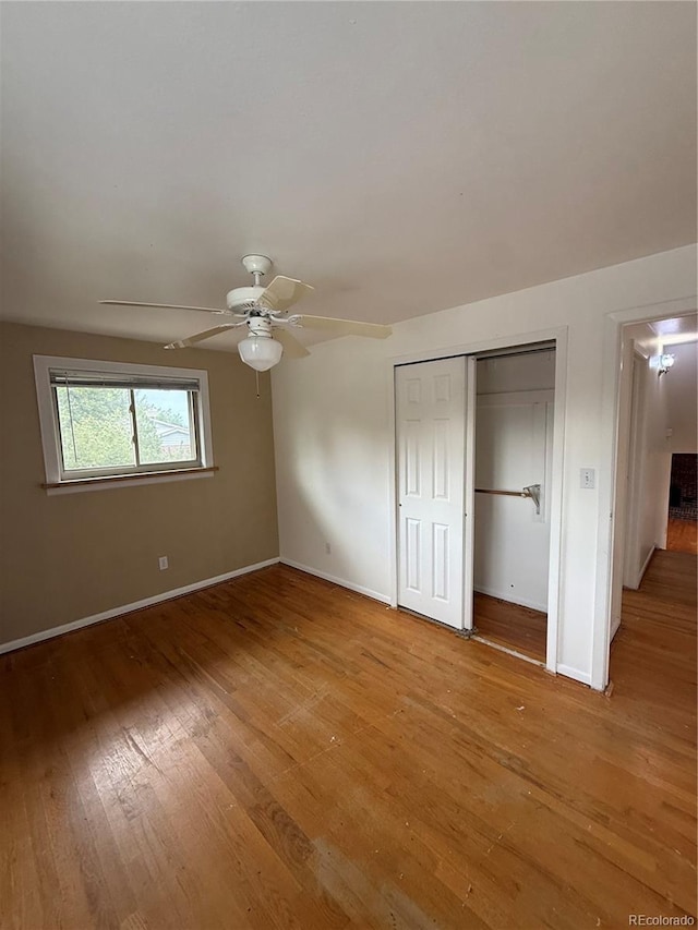 3566 E Fair Pl, Centennial, CO 80121 - unfurnished bedroom with light wood finished floors, a closet, a ceiling fan, and attic access