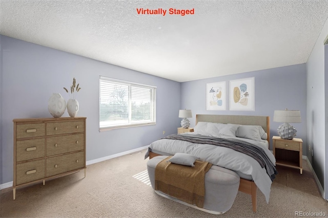 carpeted bedroom featuring a textured ceiling