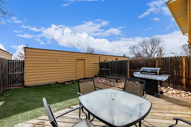 deck with area for grilling and a yard