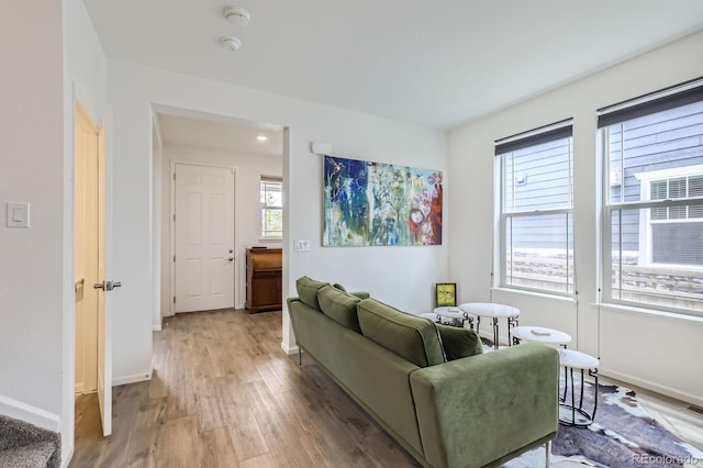 living area with baseboards and light wood-style flooring
