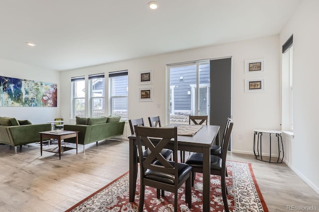 dining room featuring recessed lighting, baseboards, and light wood-style floors