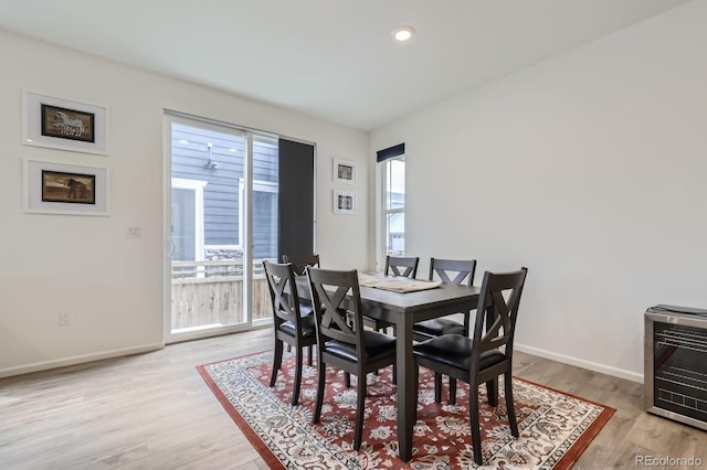 dining space featuring baseboards, recessed lighting, and light wood finished floors