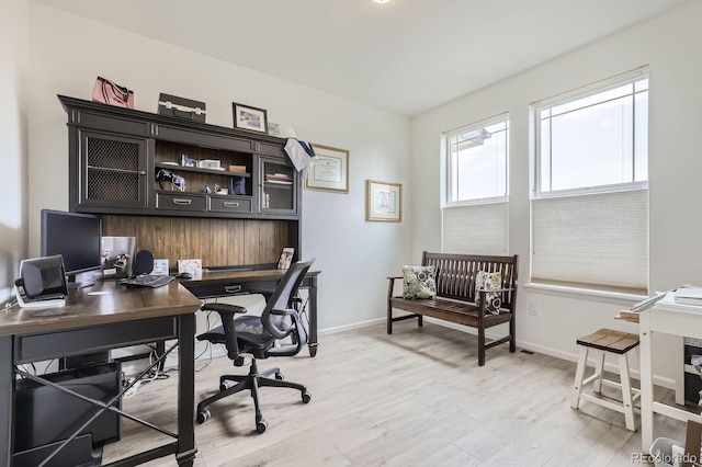 home office featuring baseboards and light wood-style flooring