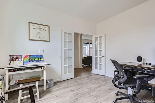 office featuring baseboards, french doors, and wood finished floors